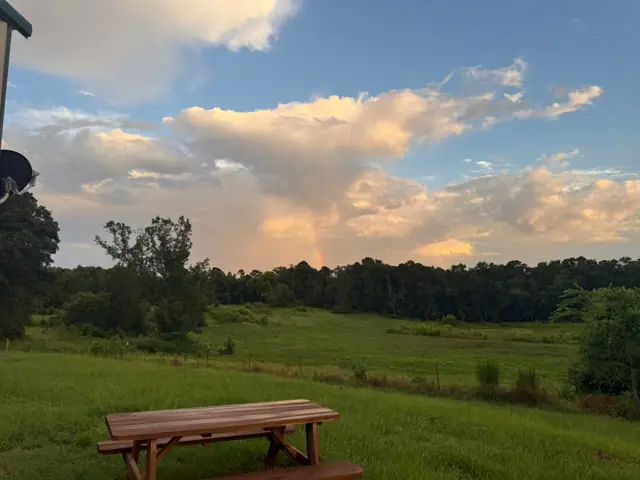 Picnic table under summer clouds